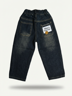 Dark wash denim jeans with yellow smiley-face patch