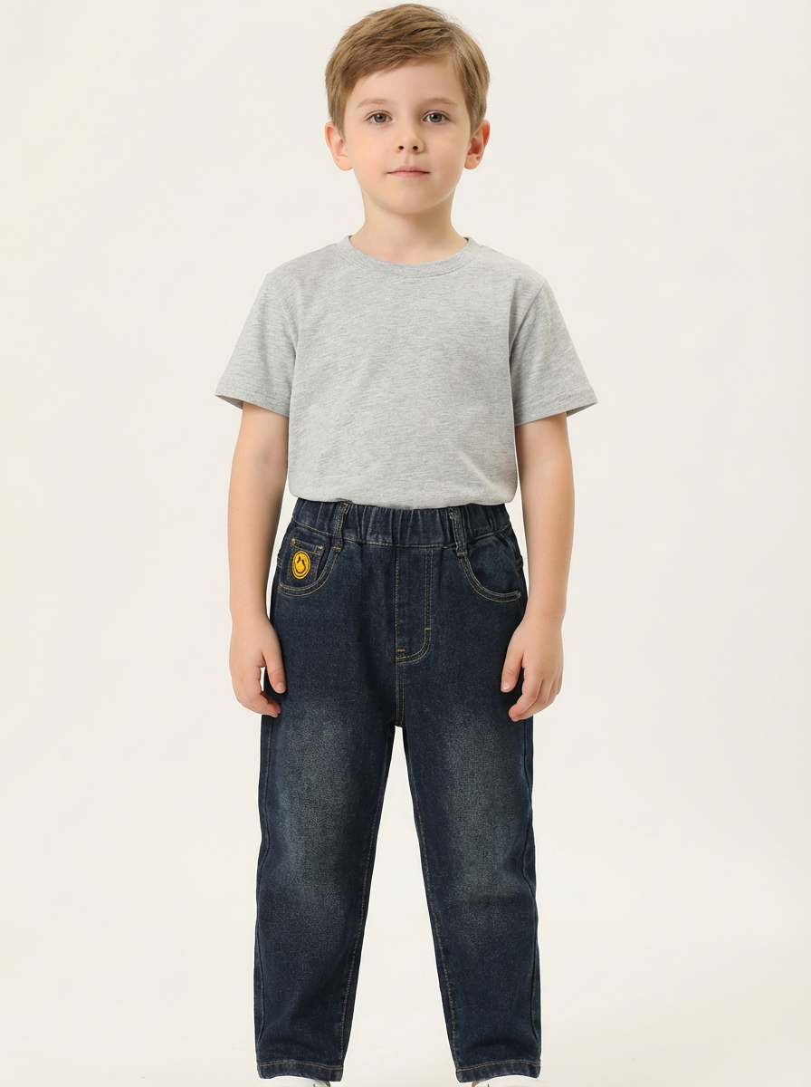 Dark wash denim jeans with yellow smiley-face patch
